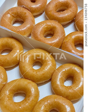 A classic glazed donut with a soft, fluffy texture and a sweet, glossy coating. Perfectly balanced between light and sugary, making it an irresistible treat for any time of the day. 134846738