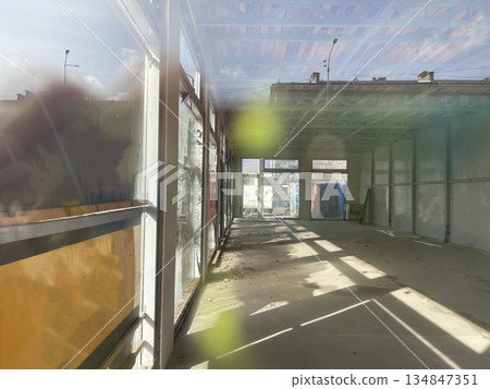 Empty weathered industrial building with sunny window Empty weathered industrial building with sunny window 134847351