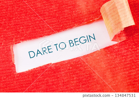 A red textured surface is torn open, revealing a message of inspiration underneath that implores you to take action and pursue new beginnings with bravery A red textured surface is torn open, revealing a message of inspiration underneath that implores you to take action and pursue new beginnings with bravery 134847531