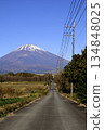 Straight paved road and power lines leading to Mount Fuji 134848025
