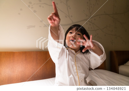 Japanese toddler girl relaxing in a luxury hotel room Japanese toddler girl relaxing in a luxury hotel room 134848921