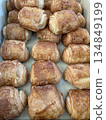 Many square croissant in a tray, high angle shot. A golden brown pastry bakery photo for breakfast, bakery shop, restaurant and cafe business concept. 134849199