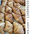 Many classic croissant in a tray, high angle shot. A golden brown pastry bakery photo for breakfast, bakery shop, restaurant and cafe business concept. 134849250