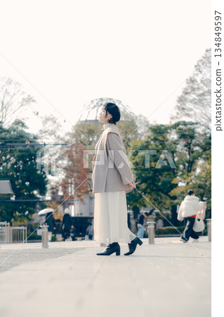 Full-body portrait of a woman in her 30s standing outdoors Full-body portrait of a woman in her 30s standing outdoors 134849597