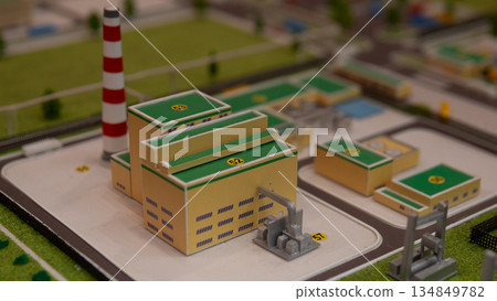 Chimney and piping detail in power plant model with engineer assessment, Gritty industrial scene showcasing power plant with emissions evaluation by engineer with textured stacks 134849782