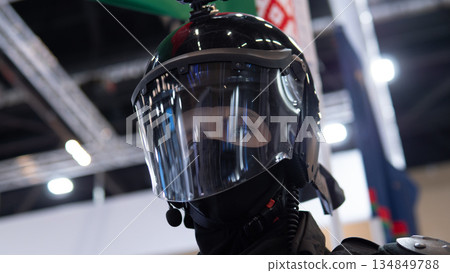 Responder wearing full face shield closeup showing clear visor, visible eyes, helmet and protective collar in exhibition setting with clinical lighting and confident professional expression Responder wearing full face shield closeup showing clear visor, visible eyes, helmet and protective collar in exhibition setting with clinical lighting and confident professional expression 134849788