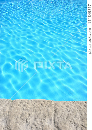The edge of an outdoor swimming pool. The edge of an outdoor swimming pool. 134849857