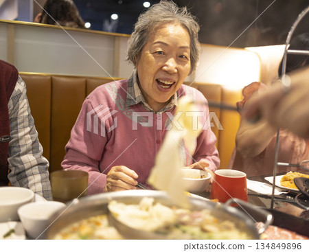Asian elderly women  Grandmother enjoys dinner with her family at the restaurant. 134849896