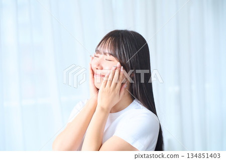 A young woman doing skin care 134851403