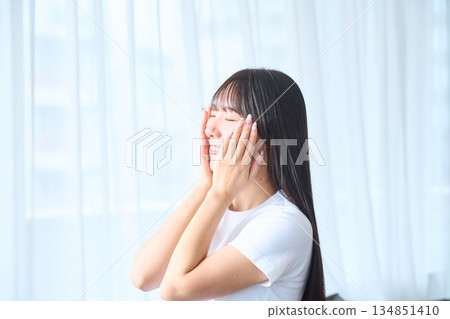 A young woman doing skin care 134851410