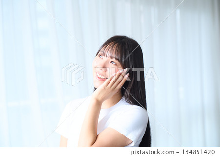 A young woman doing skin care 134851420