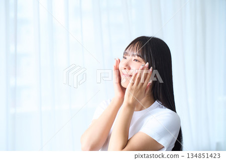 A young woman doing skin care 134851423