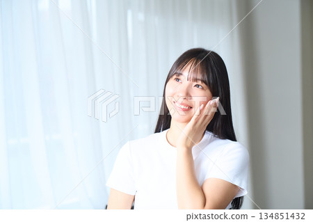 A young woman doing skin care 134851432