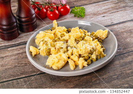 Scrambled egg omelet with green peas 134852447