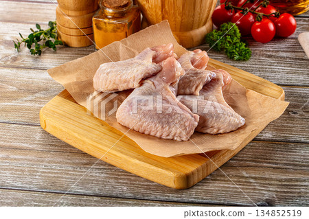 Fresh raw chicken wings over board Fresh raw chicken wings over board 134852519