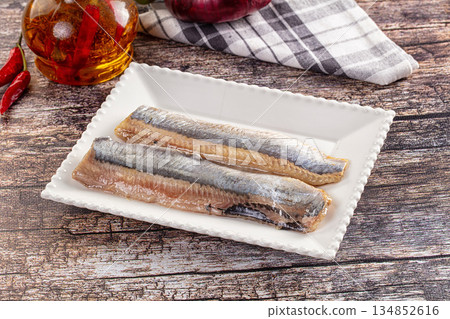 Marinated pickled salted herring fillet 134852616
