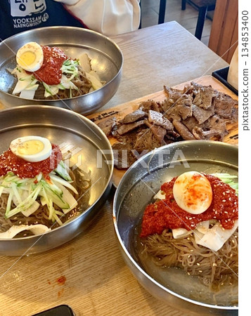 Authentic Pyongyang naengmyeon with chewy buckwheat noodles in cold, clear broth, offering a refreshing and delicate flavor. Perfect for traditional Korean cuisine menus and summer dishes. 134853400