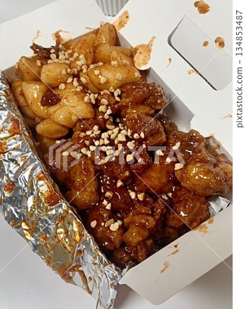 Crispy Korean fried chicken, perfectly glazed with a sweet and spicy sauce. Ideal for food photography and menus, showcasing the irresistible crunch and flavor of this beloved dish. Crispy Korean fried chicken, perfectly glazed with a sweet and spicy sauce. Ideal for food photography and menus, showcasing the irresistible crunch and flavor of this beloved dish. 134853487