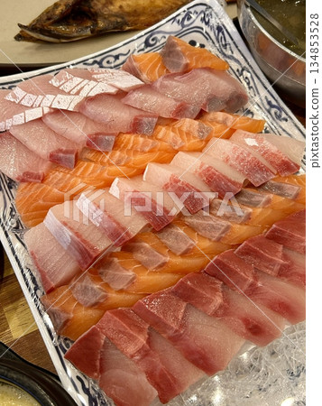 Fresh and delicate sashimi slices, beautifully presented with vibrant colors and perfect cuts. This traditional Japanese delicacy highlights the pure flavors of premium seafood. 134853528