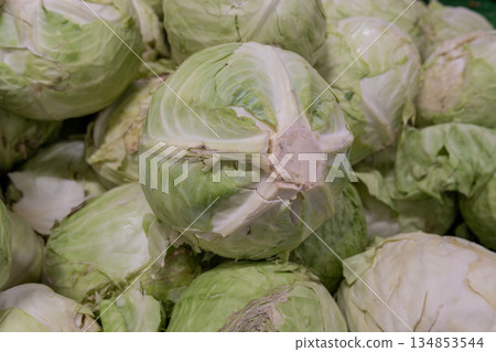 Fresh Green Cabbages Piled High in Market Display of Fresh Produce Fresh Green Cabbages Piled High in Market Display of Fresh Produce 134853544