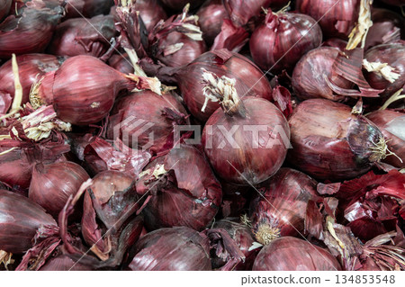 Pile Of Red Onions With Purple Skin In A Fresh Produce Display For Market And Kitchen Use 134853548