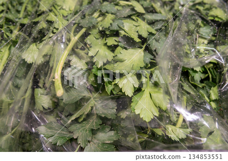 Fresh Parsley Bunch Wrapped in Clear Plastic for Fresh Produce Display in Market Fresh Parsley Bunch Wrapped in Clear Plastic for Fresh Produce Display in Market 134853551