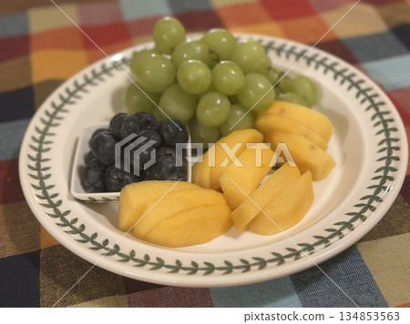 Colorful fruit platters filled with fresh, juicy slices of melon, berries, grapes, and more. Offering a perfect mix of natural sweetness, vibrant color, and refreshing flavor in every bite. 134853563