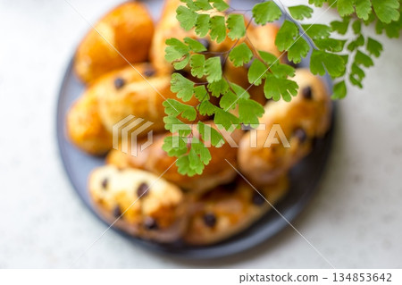 Delicious raisin scones afternoon tea set against the backdrop of maidenhair ferns 134853642