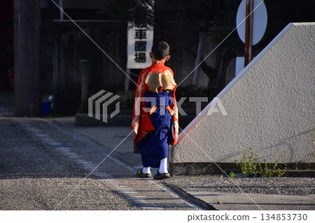 Inuyama City, Aichi Prefecture, Japan - A boy participating in the spring Inuyama Festival, wearing a traditional kimono, walking down an alleyway Inuyama City, Aichi Prefecture, Japan - A boy participating in the spring Inuyama Festival, wearing a traditional kimono, walking down an alleyway 134853730