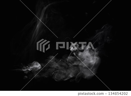 Wisps of white smoke isolated on a black background with space for text. Wisps of white smoke isolated on a black background with space for text. 134854202