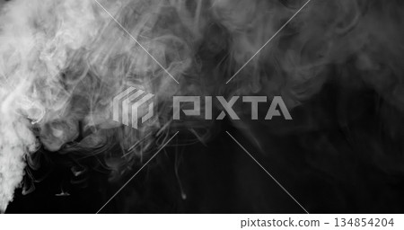 Wisps of white smoke isolated on a black background with space for text. 134854204