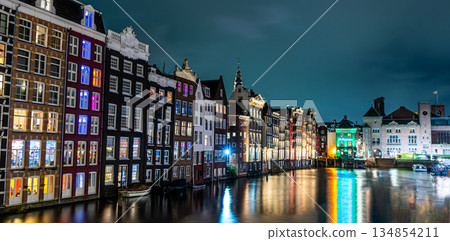 Amsterdam night. Colorful houses canal water reflection Amsterdam night. Colorful houses canal water reflection 134854211