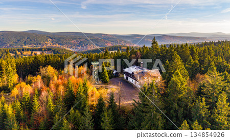 Discover the beauty of the Slovanka Lookout Tower in the Jizera Mountains during fall. The oldest iron tower in the Czech Republic offers stunning views of colorful foliage. Discover the beauty of the Slovanka Lookout Tower in the Jizera Mountains during fall. The oldest iron tower in the Czech Republic offers stunning views of colorful foliage. 134854926