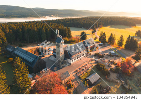 Discover the Kralovka Lookout Tower in the Jizera Mountains during autumn. The vibrant fall foliage brightens the landscape, showcasing nature's beauty and serenity. 134854945