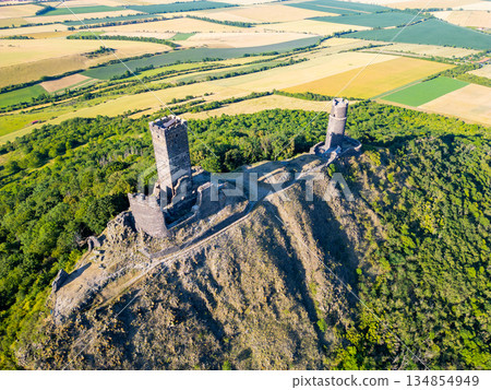 Ruins of Hazmburk castle dominate the landscape in Czechia, showcasing medieval architecture. Ruins of Hazmburk castle dominate the landscape in Czechia, showcasing medieval architecture. 134854949