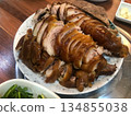 Traditional Korean Braised Pork Trotters (Jokbal) Sliced on a Plate with Garlic and Side Dishes 134855038