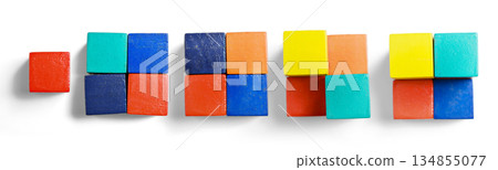 Colorful arrangement of stacked wooden cubes, demonstrating sequence. The cubes are of various colors and stacked in an ascending arrangement on a white background 134855077