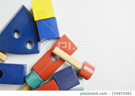 Colorful collection of wooden educational toys in various shapes stacked on a white background. Early childhood development, learning through play, and creative building 134855081