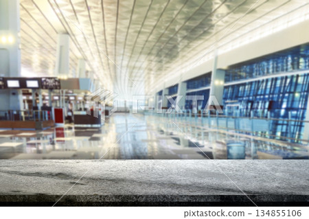 Blurred background image of a modern airport terminal interior with a marble countertop foreground, suitable for product mockups and displays. Ideal for travel, tourism, and business presentations Blurred background image of a modern airport terminal interior with a marble countertop foreground, suitable for product mockups and displays. Ideal for travel, tourism, and business presentations 134855106