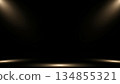 Spotlight Stage with Golden Light Beams on Black Background 134855321