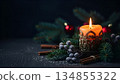 Warm Christmas Candle with Festive Decorations and Pine Branches 134855322