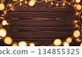 Warm Glowing Christmas Lights Frame on Dark Wooden Background 134855325
