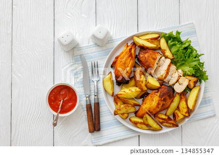 grilled juicy chicken breasts and roasted potatoes grilled juicy chicken breasts and roasted potatoes 134855347