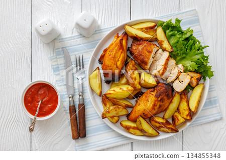 grilled juicy chicken breasts and roasted potatoes 134855348