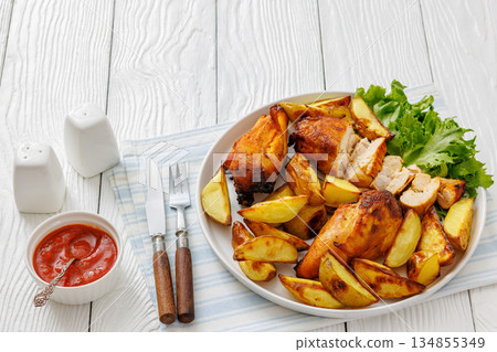 grilled juicy chicken breasts and roasted potatoes grilled juicy chicken breasts and roasted potatoes 134855349