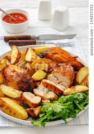 grilled juicy chicken breasts and roasted potatoes 134855352