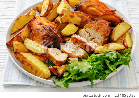 grilled juicy chicken breasts and roasted potatoes grilled juicy chicken breasts and roasted potatoes 134855353