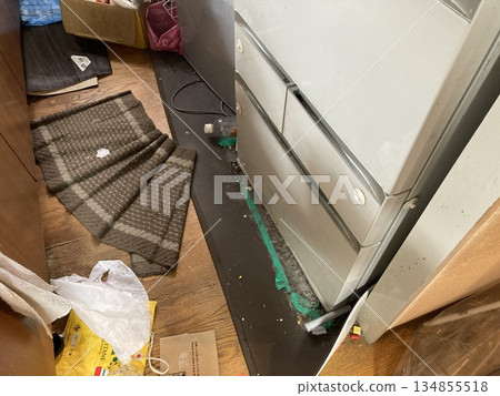 Messy floor and refrigerator around the kitchen Messy floor and refrigerator around the kitchen 134855518