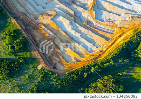 The sandstone quarry at Strelec in Czechia. Workers extract sandstone from the ground while large machinery operates nearby. The landscape features trees and earth moving. The sandstone quarry at Strelec in Czechia. Workers extract sandstone from the ground while large machinery operates nearby. The landscape features trees and earth moving. 134856082