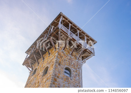 A historic lookout tower stands tall on Wysoki Kamien. This structure offers stunning views of the surrounding Jizera Mountains, perfect for hikers and nature lovers exploring the area. A historic lookout tower stands tall on Wysoki Kamien. This structure offers stunning views of the surrounding Jizera Mountains, perfect for hikers and nature lovers exploring the area. 134856097